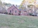 Brick house with a gray roof and a large grassy yard at 121 Sierra Woods Dr, Troutman, NC 28166