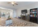 Open living room with fireplace, TV, and access to kitchen at 13883 Clayborn St, Midland, NC 28107