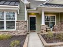 Inviting front entrance with a dark door and stone detailing at 1410 Tranquility Blvd, Lancaster, SC 29720