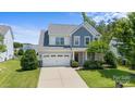 Two-story house with gray siding, white trim, and a two-car garage at 17527 Austins Creek Dr, Charlotte, NC 28278