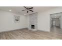 Living room featuring hardwood floors and a whitewashed brick fireplace at 207 Faulkner St, Clover, SC 29710