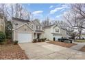 Two story house with a white garage door and view of the street and neighboring houses at 2604 Cochrane Dr, Charlotte, NC 28269