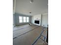 Spacious living room featuring a modern fireplace with a shiplap surround and abundant natural light at 3240 Mcharney Dr # 36, Harrisburg, NC 28075