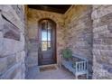 Inviting entryway with a wooden door and a welcoming bench at 4010 Soleado Dr, Matthews, NC 28104