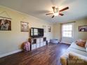 Living room with hardwood floors, ceiling fan, and comfy couch at 44743 Fish Camp Rd, New London, NC 28127