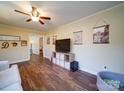 Living room with hardwood floors and view into another room at 44743 Fish Camp Rd, New London, NC 28127