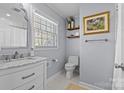 Updated bathroom with white vanity, marble countertop, and hexagon tile floor at 4526 Wedgewood Dr, Charlotte, NC 28210