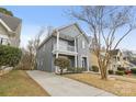 Two-story gray house with driveway and surrounding houses visible at 4827 Eaves Ln, Charlotte, NC 28215