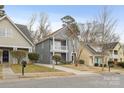 Two-story gray house on a street with other houses at 4827 Eaves Ln, Charlotte, NC 28215