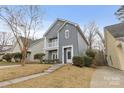 Two-story gray house with a balcony and landscaping at 4827 Eaves Ln, Charlotte, NC 28215