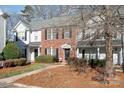 Brick and white townhome with landscaping and walkway at 8044 Sapwood Ct, Matthews, NC 28104