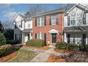 Two story townhome with a brick exterior and landscaping at 8044 Sapwood Ct, Matthews, NC 28104