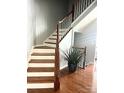 Elegant staircase with hardwood treads and white risers at 9323 Lenox Pointe Dr, Charlotte, NC 28273