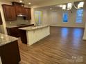 Open kitchen with granite countertops and island at 10028 Nw Trailhead Nw Way, Huntersville, NC 28078