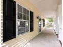 Front porch with white railing and black shutters at 104 Pratt St, Belmont, NC 28012