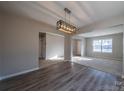 Dining room with wood-look flooring and a modern light fixture at 10502 Haddington Nw Dr, Charlotte, NC 28269