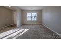 Spacious living room featuring carpeted floors and ample natural light at 10502 Haddington Nw Dr, Charlotte, NC 28269