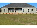 Rear view of a house showing a deck and grassy backyard at 226 Beths Ct, York, SC 29745