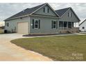 Home showcasing a side-entry garage, green siding, and a neatly kept lawn at 226 Beths Ct, York, SC 29745