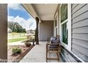 Inviting front porch with a bench and view of the neighborhood at 3226 Mcharney Dr # 35, Harrisburg, NC 28075