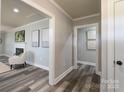 Bright hallway with hardwood floors, leading to living room and other areas of the home at 6211 Rock Island Rd, Charlotte, NC 28278