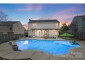 Inviting in-ground pool with a pergola-covered patio at 7647 Black Hawk Ln, Tega Cay, SC 29708