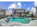 Relaxing in-ground pool with a pergola and patio furniture at 7647 Black Hawk Ln, Tega Cay, SC 29708