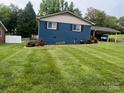 Blue ranch home with a well-manicured lawn and landscaping at 904 Mascot Dr, Albemarle, NC 28001