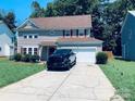 Attractive two-story home with a gray exterior, red shutters, and a spacious driveway at 9624 Langston Mill Rd, Charlotte, NC 28216