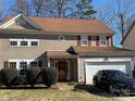 Two-story house with brown siding, red shutters, and a two-car garage at 9624 Langston Mill Rd, Charlotte, NC 28216