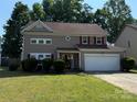 Charming two-story home with a well-maintained lawn, inviting entrance, and attached two-car garage at 9624 Langston Mill Rd, Charlotte, NC 28216