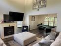 Inviting living room with vaulted ceilings, fireplace, plush furniture, and a view into the recreation room at 9624 Langston Mill Rd, Charlotte, NC 28216