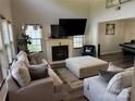 Inviting living room with vaulted ceilings, fireplace, plush furniture, and a view into the recreation room at 9624 Langston Mill Rd, Charlotte, NC 28216