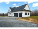 White two-car garage with black doors and gravel driveway at 1026 Walker Branch Rd, Lincolnton, NC 28092