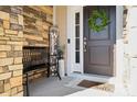 Front entrance with stonework, a black bench, and a welcome sign at 1248 Thomas Knapp Pkwy, Fort Mill, SC 29715