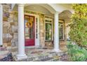 Stone and columned porch with red door and wreath at 1257 Stacey Ln, Indian Land, SC 29707