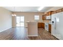 Kitchen with wood cabinets, white appliances, and breakfast bar at 13441 Calloway Glen Dr, Charlotte, NC 28273