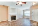 Living room with hardwood floors, fireplace, and built-in shelving at 13441 Calloway Glen Dr, Charlotte, NC 28273