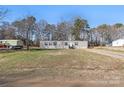 Single-story home with gray siding, black shutters and large grassy front yard at 1805 Drew Dr, Lincolnton, NC 28092