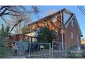 Back view of a brick house with a deck and fenced yard at 2101 Russell Ave, Charlotte, NC 28216