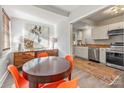 Modern dining room with a round table and four orange chairs at 2601 Columbus Cir, Charlotte, NC 28208