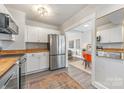 Updated kitchen with stainless steel appliances and butcher block counters at 2601 Columbus Cir, Charlotte, NC 28208