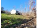 House nestled in a wooded area with a deck at 34466 Lisa Dr, Albemarle, NC 28001