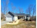 Gray house with white garage door and stone accents at 34466 Lisa Dr, Albemarle, NC 28001