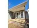 Stone-paved porch with a wooden post and wreath at 34466 Lisa Dr, Albemarle, NC 28001