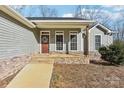 Inviting front porch with stone steps, leading to a charming front door at 34466 Lisa Dr, Albemarle, NC 28001