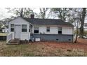 House backyard with gray brick base and wood chips at 5917 Peach St, Charlotte, NC 28269