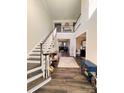 Two-story foyer with hardwood floors, elegant staircase, and natural light at 6022 Candlestick Ln, Lancaster, SC 29720