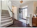 Bright entryway with staircase, hardwood floors, and wreath at 6142 Cloverdale Dr, Tega Cay, SC 29708