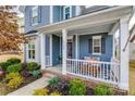 Charming front porch with white railing and seating area at 6142 Cloverdale Dr, Tega Cay, SC 29708